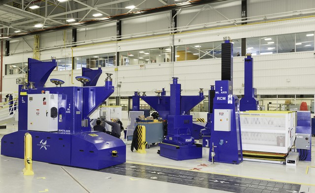 two technicians servicing large industrial machines