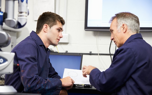 senior technician talking with student