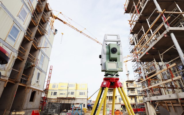 total station in use measuring buildings