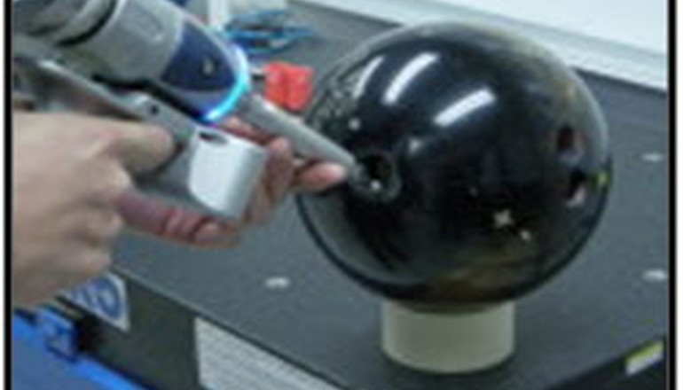 bowling ball being scanned with a portable arm