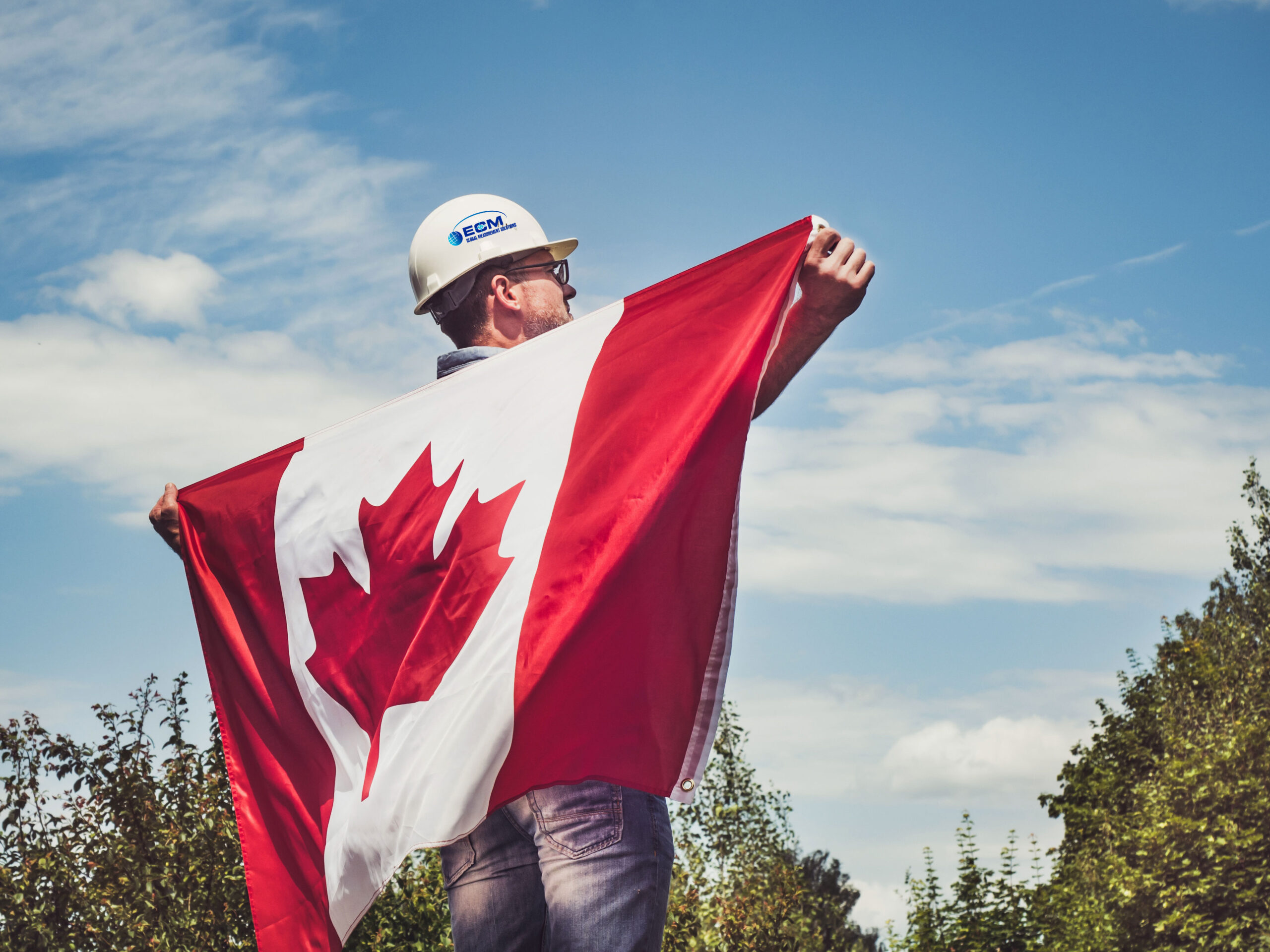 ECM employee holding Canadian flag